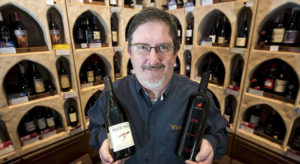 Jerry Janssen holding two bottles of wine